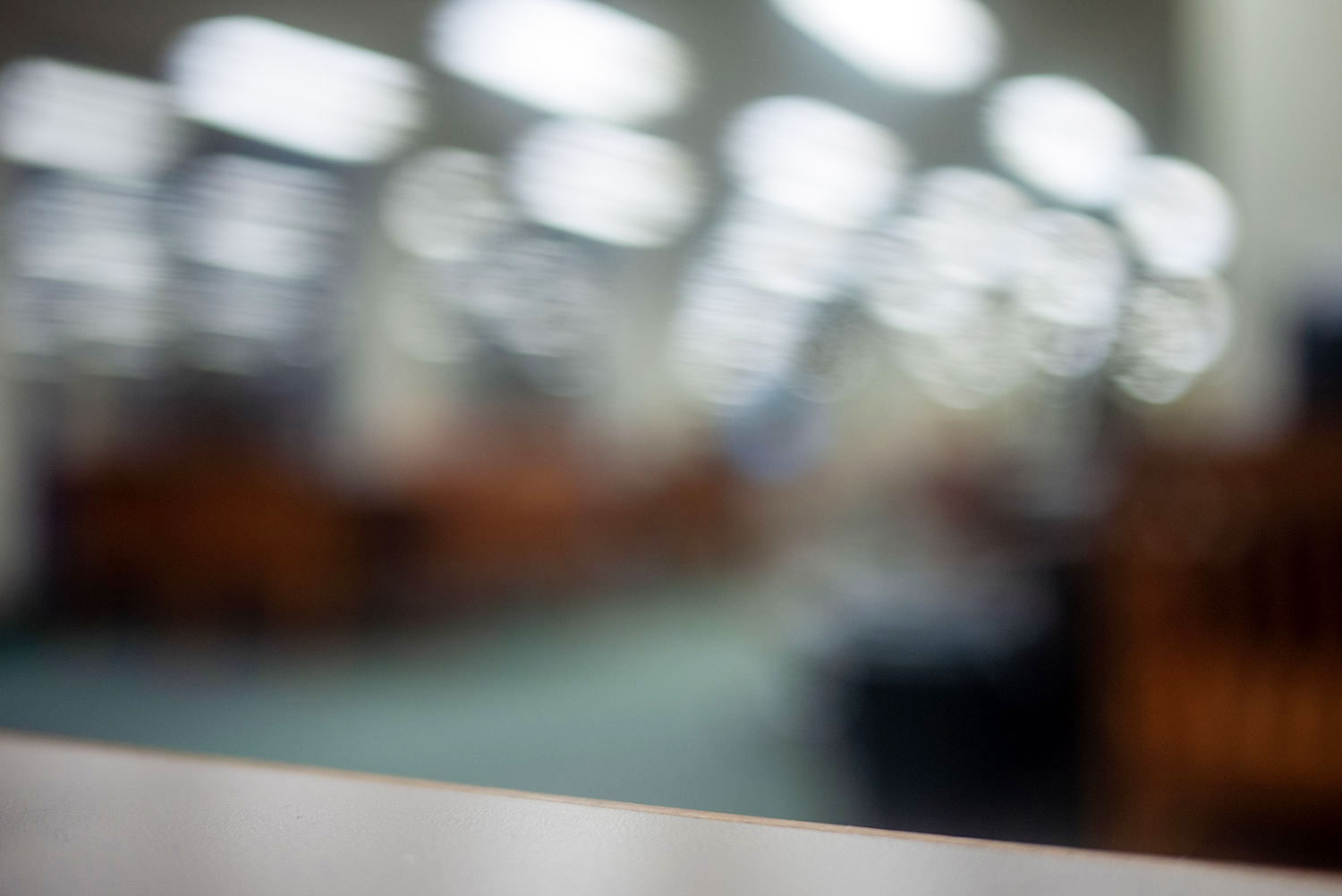 A blurry image of what may be a reference room in a university library, but could be some other liminal space