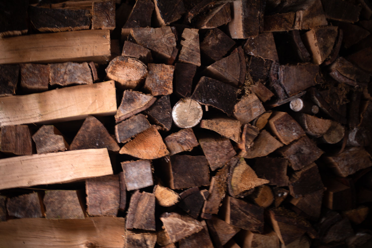 A somewhat blurry photograph of some stacked firewood