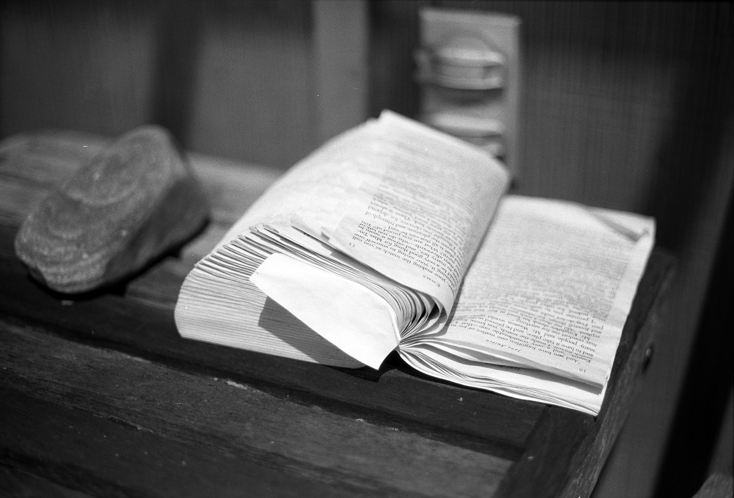 A scan of a black and white film photograph of a book that was left outside overnight, with pages wrinkled by the damp