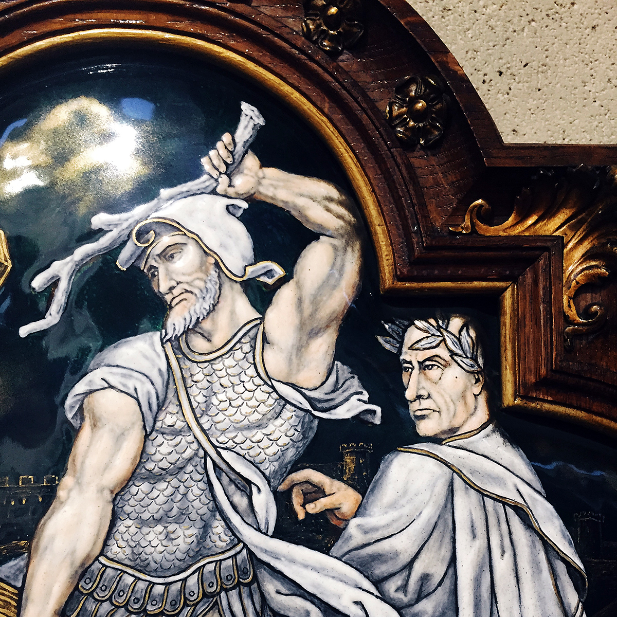 The image of a man raises a club to do some violence on a painted tile